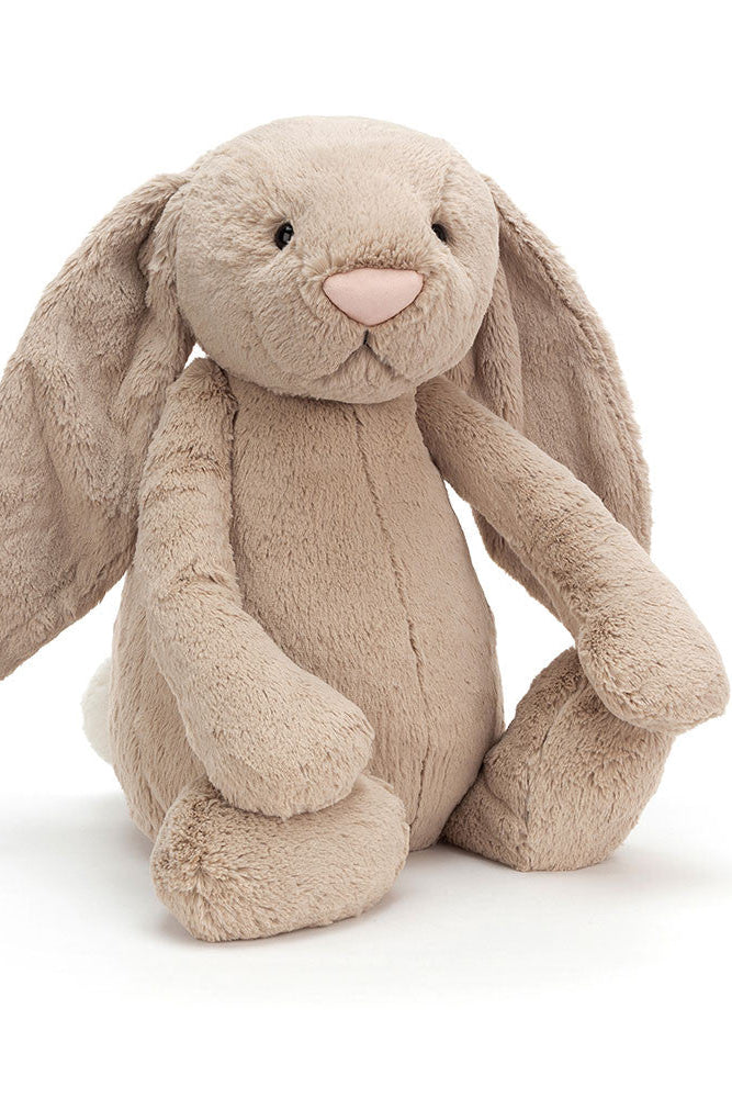Photo of Beige Bunny Stuffed Animal with long floppy ears and pink nose on a white background. Sitting up and black button eyes