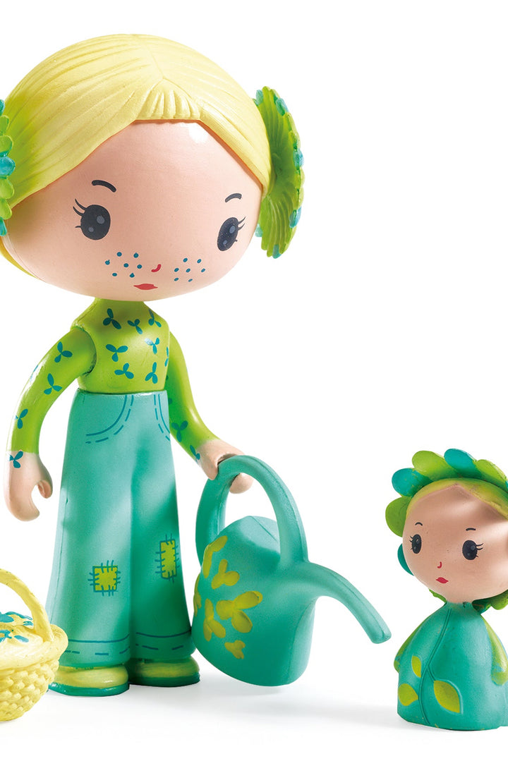 Toy figure of a girl with a smaller figure and accessories on a white background