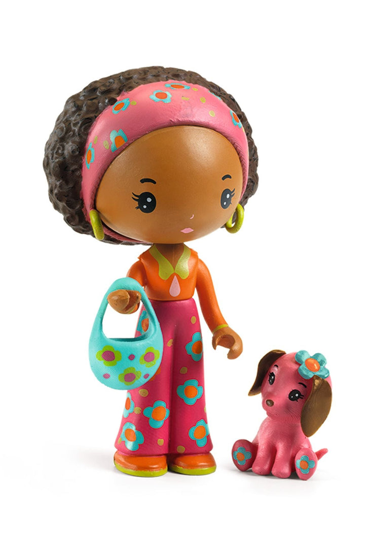 Toy figure of a girl with a dog on a white background