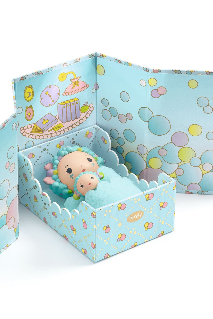 Toy figure in a decorative box with bubble-themed design on a white background
