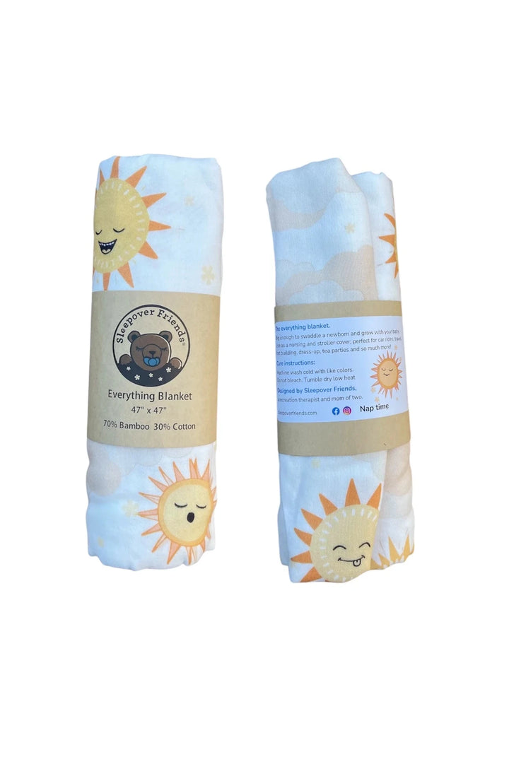Two folded baby blankets with sun designs and labels on a white background