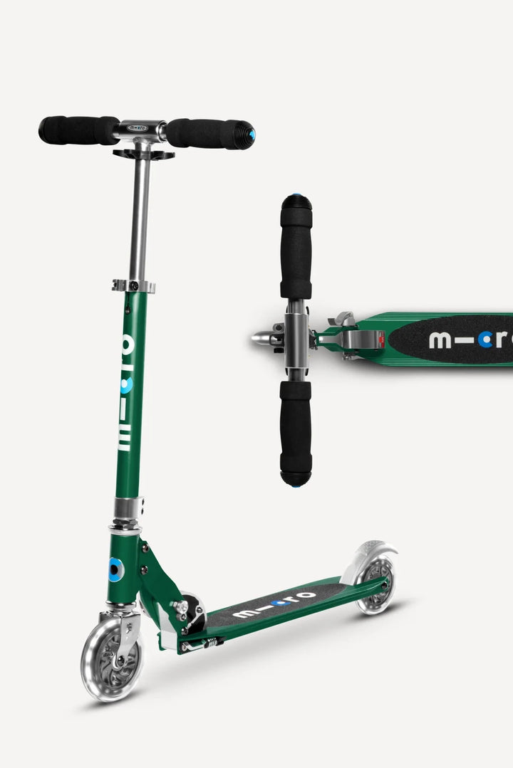 Green scooter with black handlebars on a white background