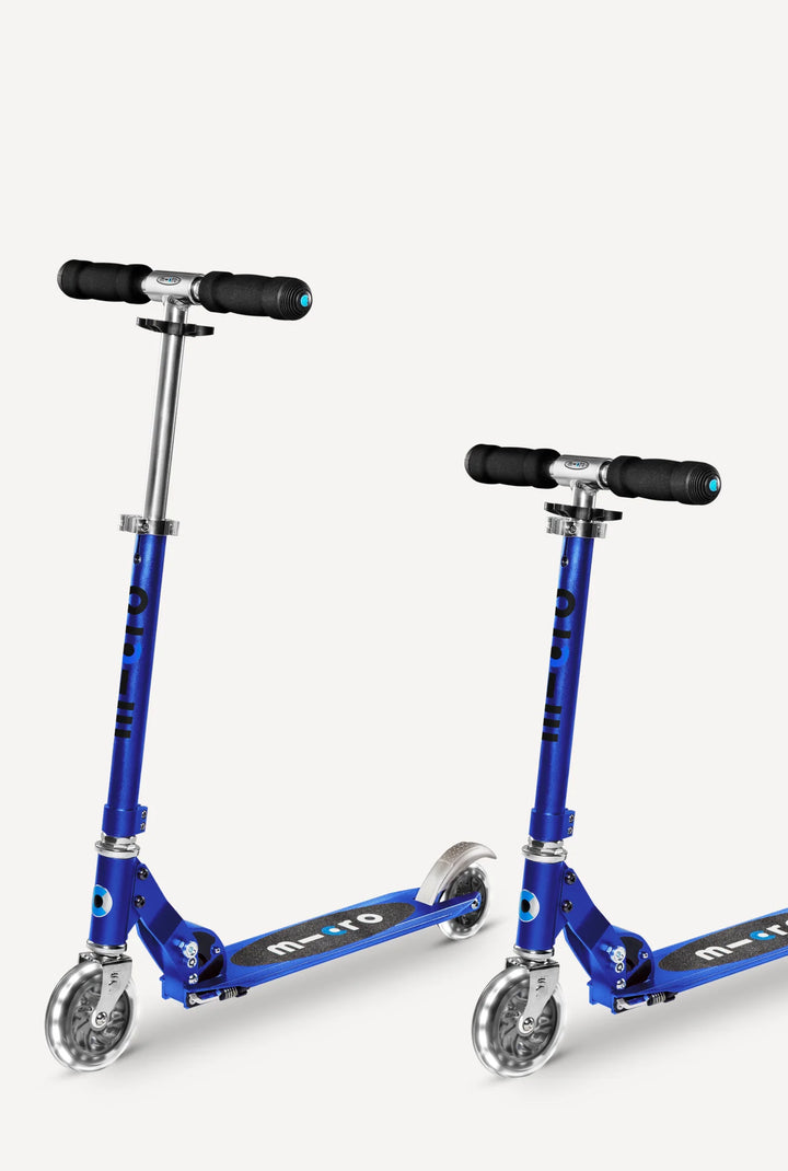 Two blue scooter with black handles on a white background