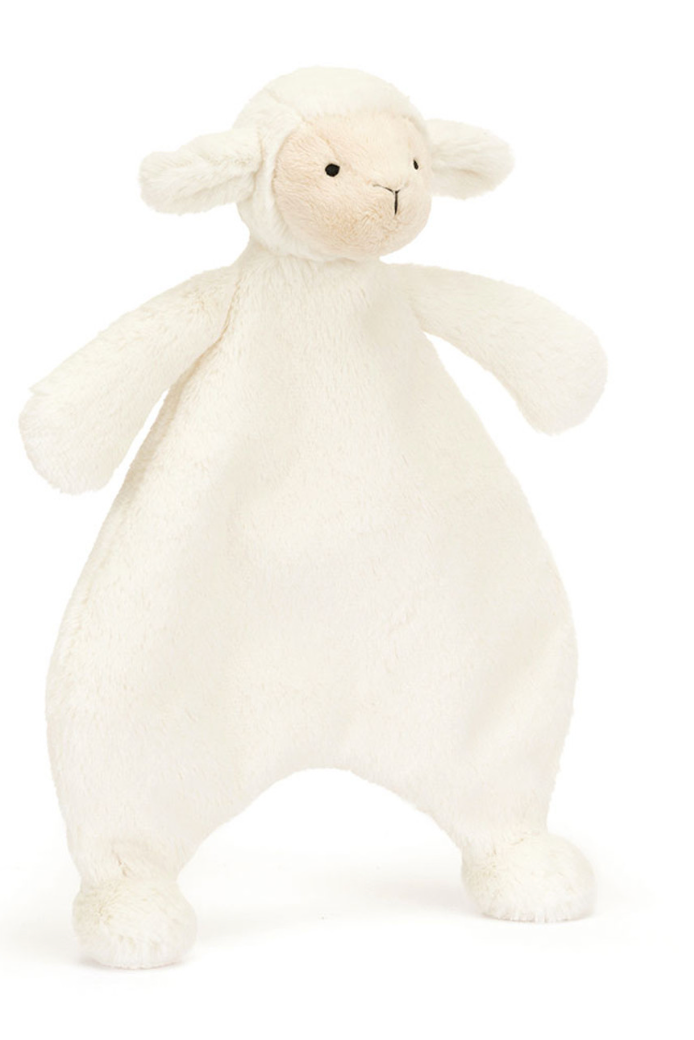 White plush lamb toy on a white background