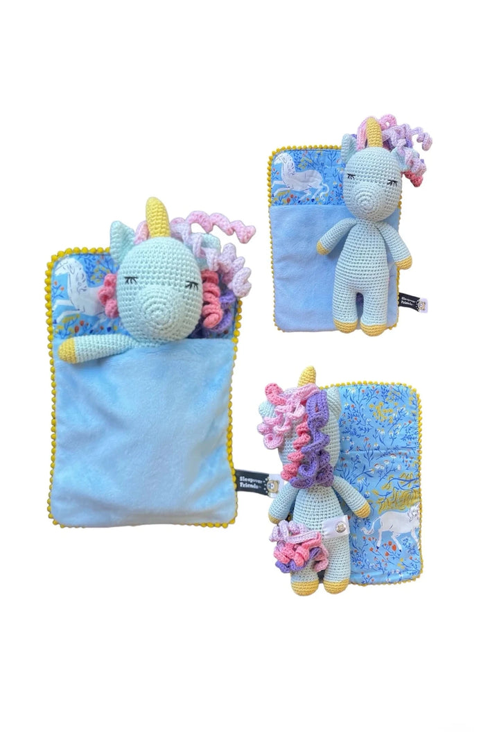 Set of three crocheted unicorn toys with colorful hair on blue fabric backgrounds.